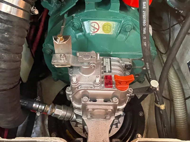 Slide: The Image of Engine compartment of a 2001 C&C 121 sailboat, featuring mechanical components and hoses. - 42