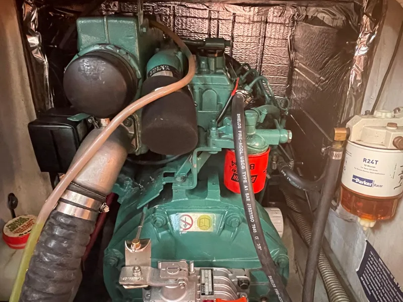 Slide: The Image of Engine compartment of a 2001 C&C 121 sailboat, featuring a well-maintained marine engine. - 43