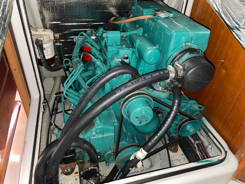 Slide: The Image of Engine compartment of a 2001 C&C 121 sailboat, featuring a well-maintained marine engine. - 47