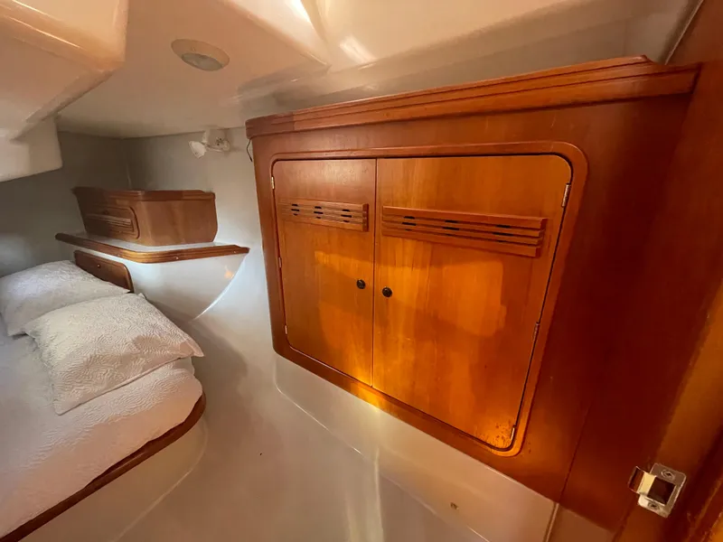 Slide: The Image of Cozy cabin interior of 2001 C&C 121 sailboat with wooden cabinetry and bed. - 48