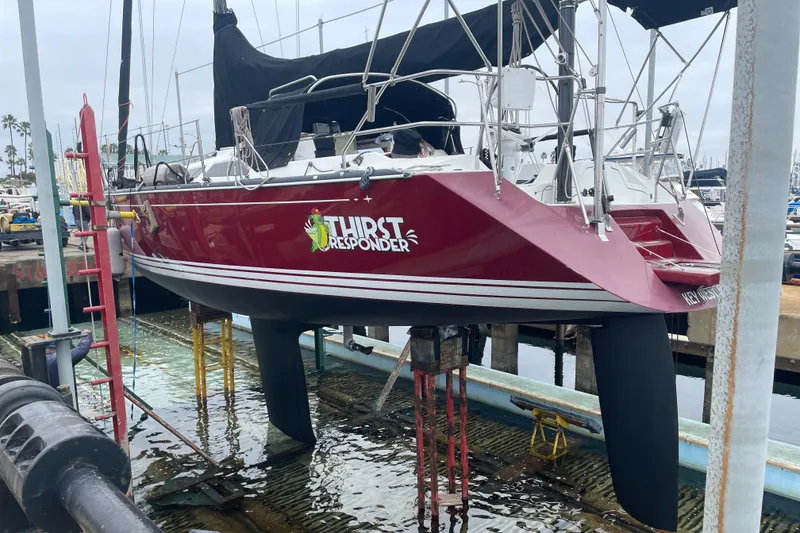 Slide: The Image of Red C&C 121 sailboat named "Thirst Responder" in dry dock, 2001 model. - 7