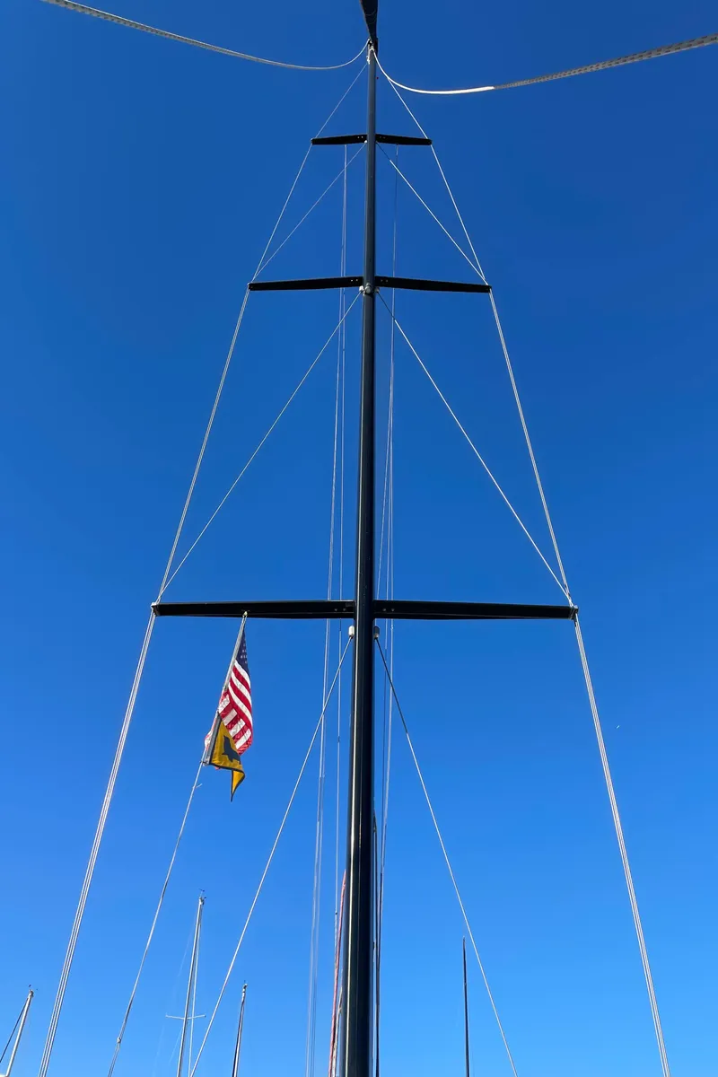 Slide: The Image of Sailboat mast with American flag against clear blue sky, C&C 121, 2001 model. - 8