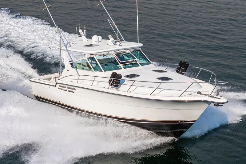 Slide: The Image of 2002 Tiara Yachts 4100 Open cruising on water, showcasing sleek design and performance. - 10