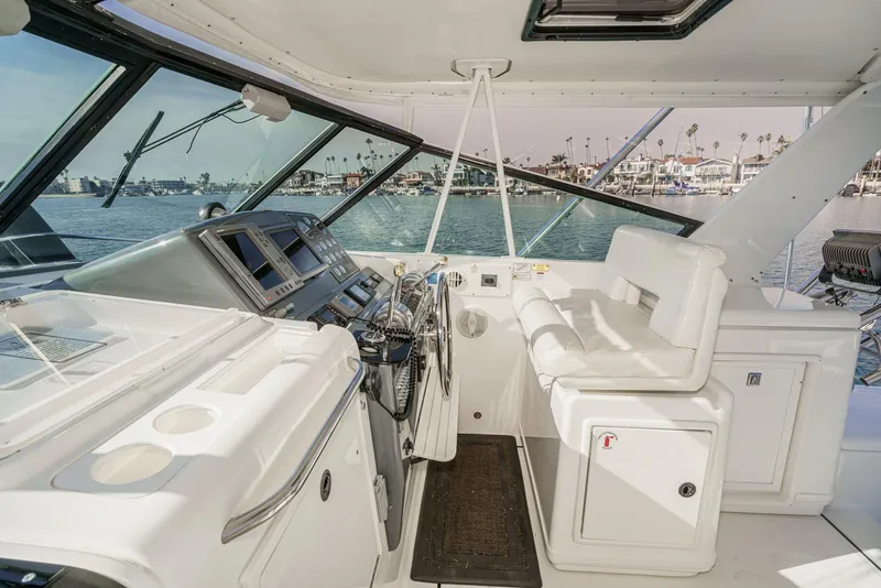 Slide: The Image of 2002 Tiara Yachts 4100 Open helm with modern controls and waterfront view. - 13
