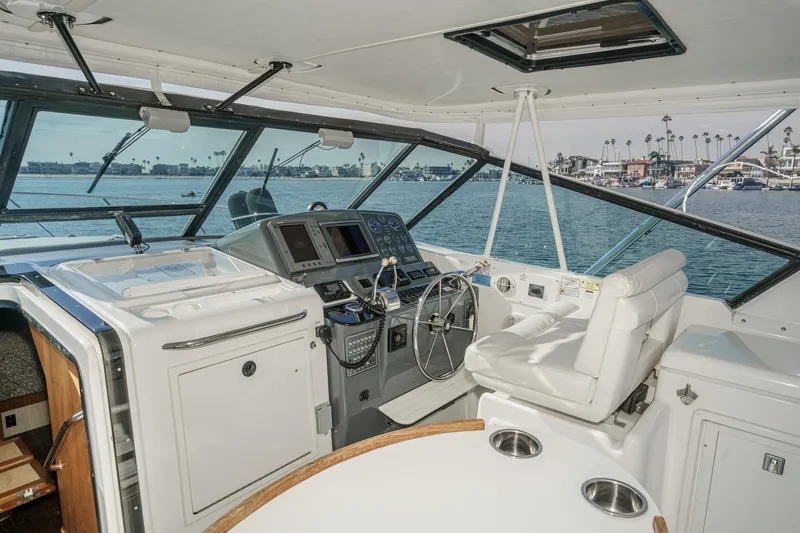Slide: The Image of 2002 Tiara Yachts 4100 Open helm with ocean view and modern controls. - 14