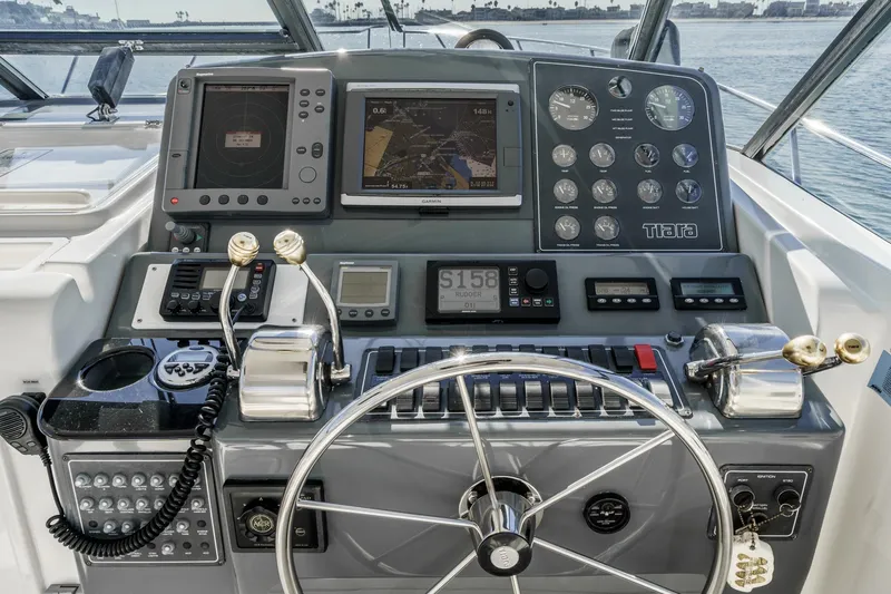 Slide: The Image of 2002 Tiara Yachts 4100 Open helm with navigation instruments and steering wheel. - 16