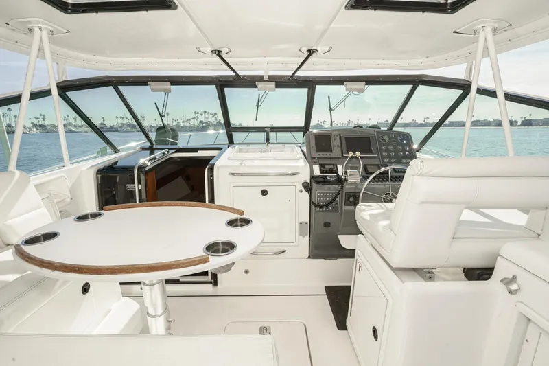 Slide: The Image of 2002 Tiara Yachts 4100 Open cockpit with helm, seating, and ocean view. - 18