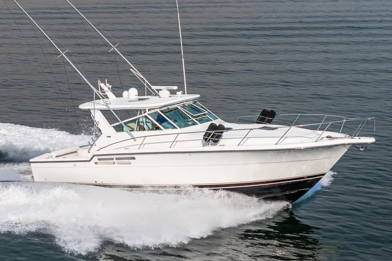 Slide: The Image of 2002 Tiara Yachts 4100 Open cruising on water, showcasing sleek design and performance. - 2