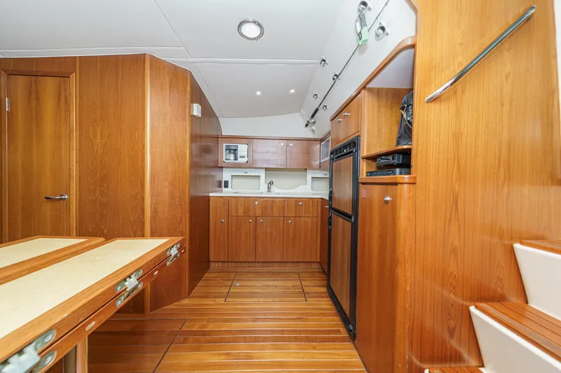 Slide: The Image of 2002 Tiara Yachts 4100 Open interior with wooden cabinetry and modern kitchen appliances. - 21