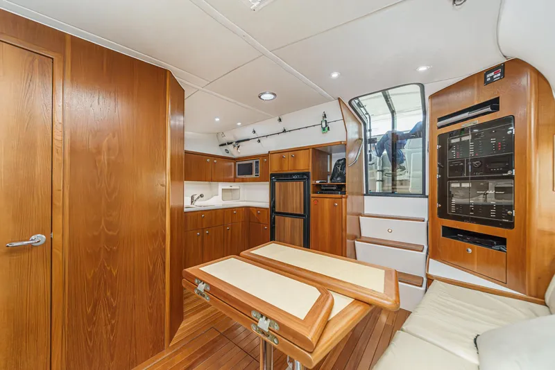 Slide: The Image of 2002 Tiara Yachts 4100 Open interior with wood cabinetry and modern amenities. - 24