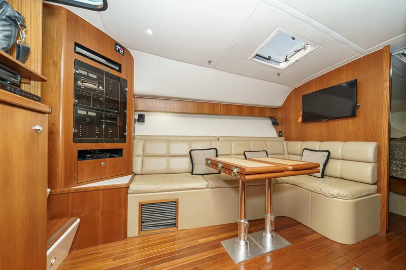 Slide: The Image of Luxurious interior of 2002 Tiara Yachts 4100 Open with leather seating and wooden accents. - 25