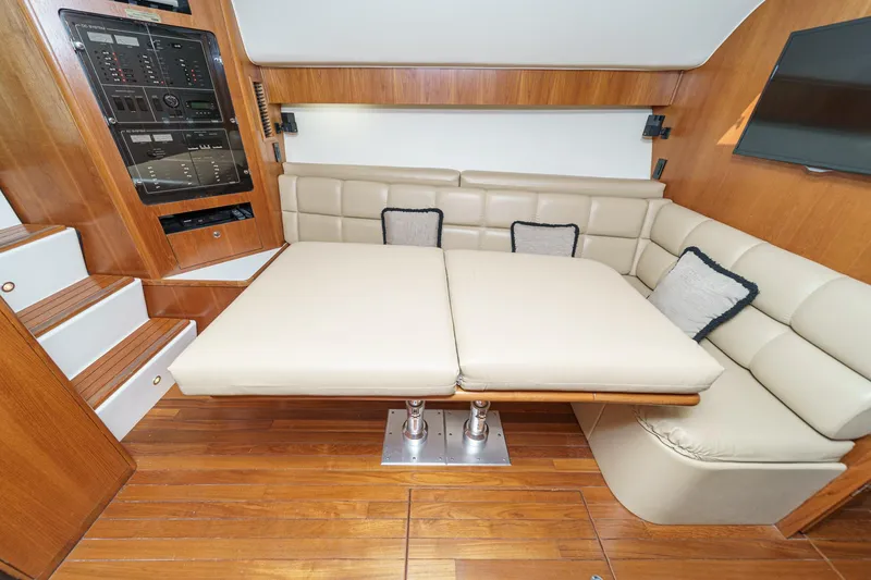 Slide: The Image of Luxurious interior of 2002 Tiara Yachts 4100 Open with plush seating and wooden accents. - 26