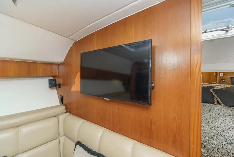 Slide: The Image of Interior of 2002 Tiara Yachts 4100 Open with TV and beige seating. - 29