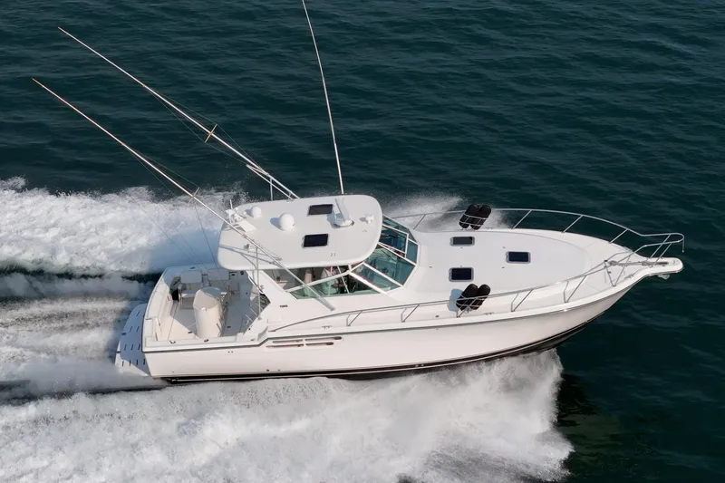 Slide: The Image of 2002 Tiara Yachts 4100 Open cruising on the ocean, showcasing sleek design and powerful performance. - 3