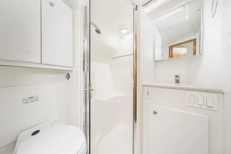 Slide: The Image of 2002 Tiara Yachts 4100 Open bathroom with shower, sink, and storage cabinets. - 30