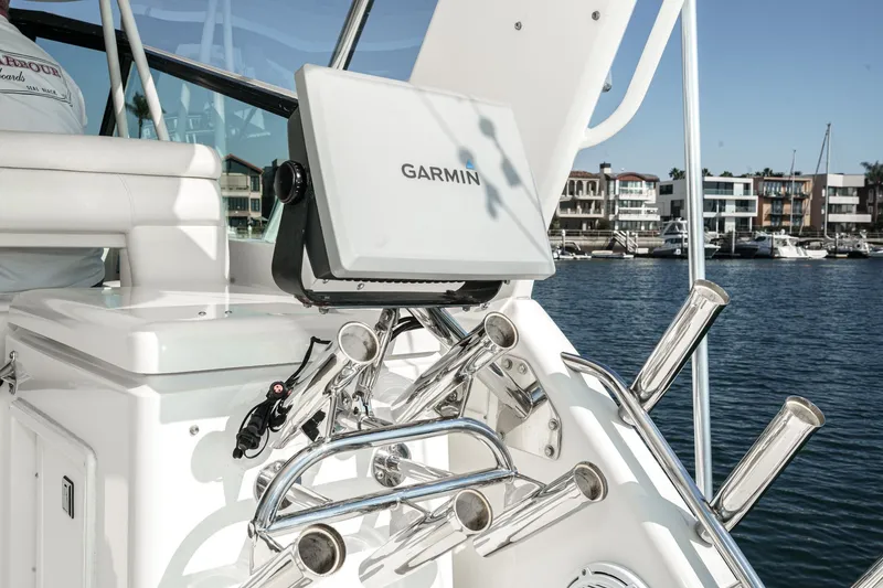 Slide: The Image of 2002 Tiara Yachts 4100 Open with Garmin navigation, docked in a marina. - 31