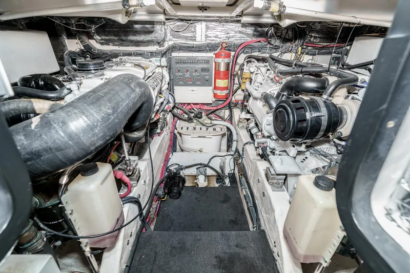 Slide: The Image of Engine room of 2002 Tiara Yachts 4100 Open, showcasing mechanical components and fire extinguisher. - 32