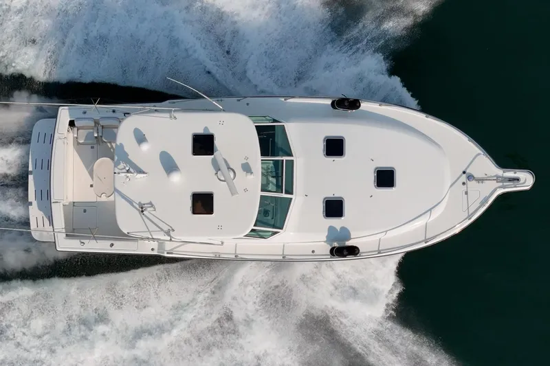 Slide: The Image of Overhead view of 2002 Tiara Yachts 4100 Open cruising on water. - 4