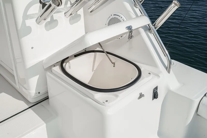Slide: The Image of 2002 Tiara Yachts 4100 Open boat storage compartment with open lid, near water. - 41