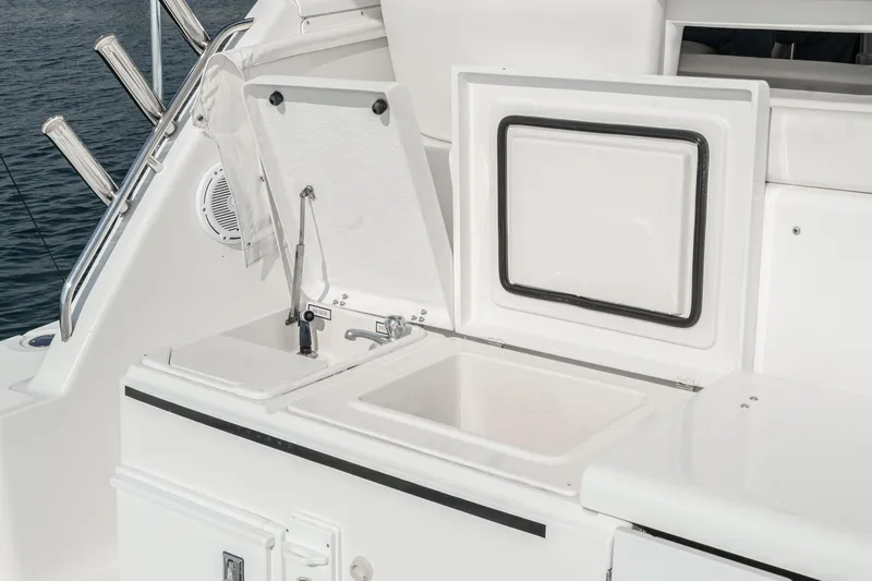 Slide: The Image of 2002 Tiara Yachts 4100 Open boat deck with sink and storage compartments. - 43