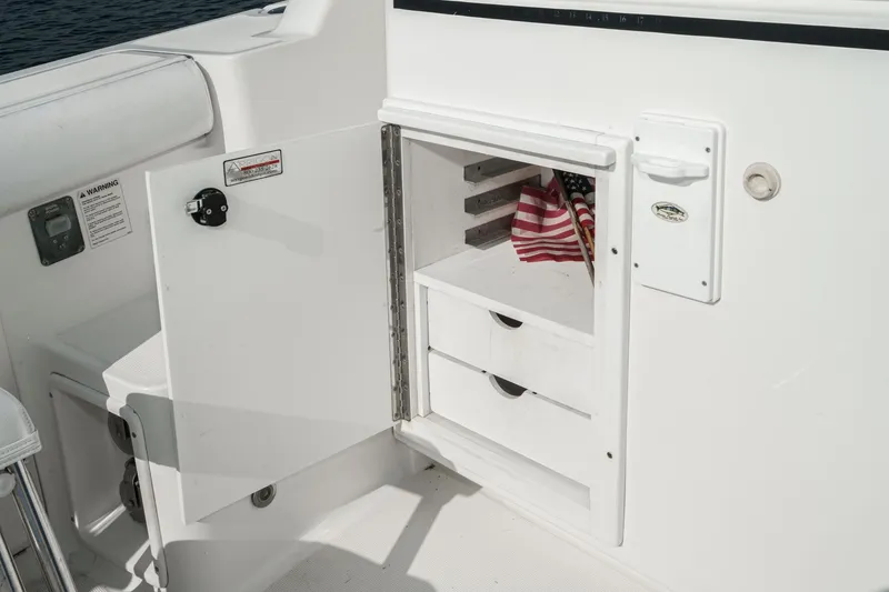 Slide: The Image of 2002 Tiara Yachts 4100 Open storage compartment with drawers and American flag. - 44
