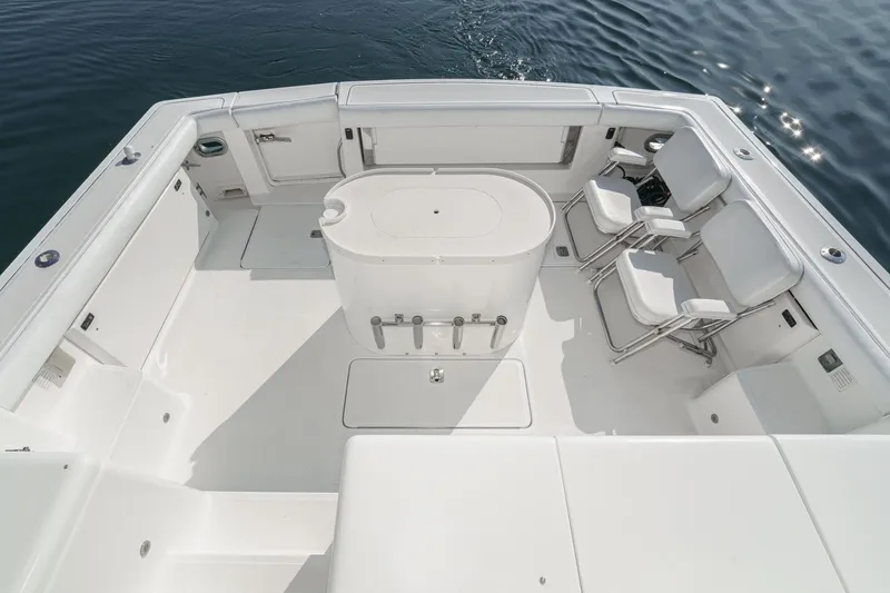 Slide: The Image of 2002 Tiara Yachts 4100 Open boat deck with seating and storage, on calm water. - 48
