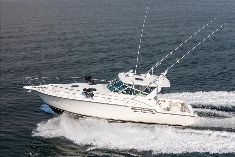 Slide: The Image of 2002 Tiara Yachts 4100 Open cruising on open water, side view. - 5