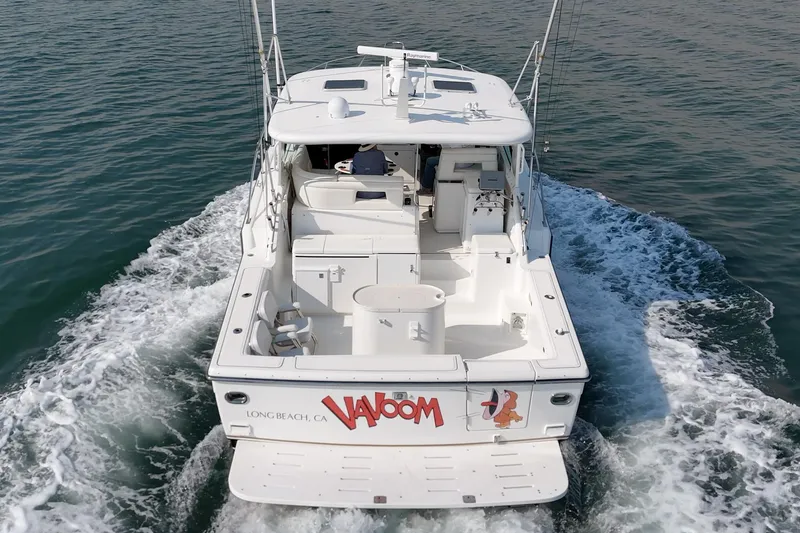 Slide: The Image of 2002 Tiara Yachts 4100 Open cruising on water, rear view, white exterior. - 6
