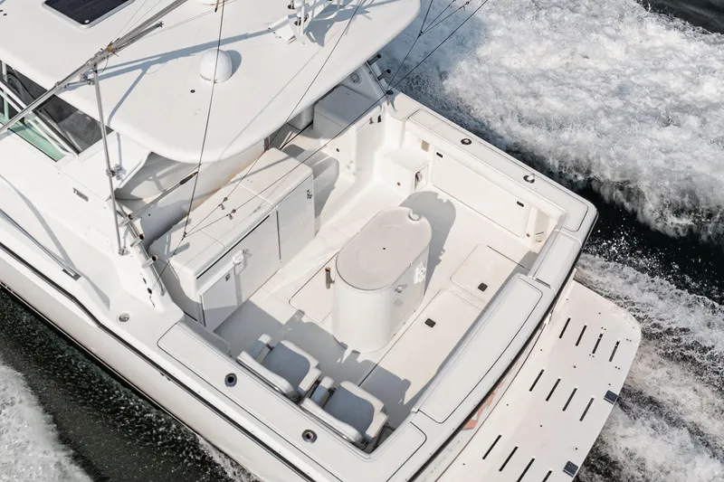 Slide: The Image of 2002 Tiara Yachts 4100 Open cruising on water, aerial view of spacious deck. - 9