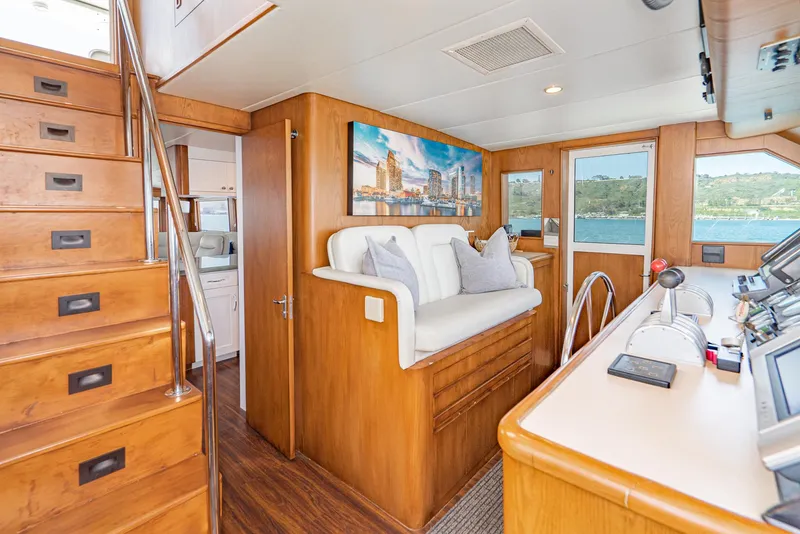 Slide: The Image of Interior of 1996 Hatteras 70 Sport Deck Motor Yacht with wooden finishes and seating area. - 14