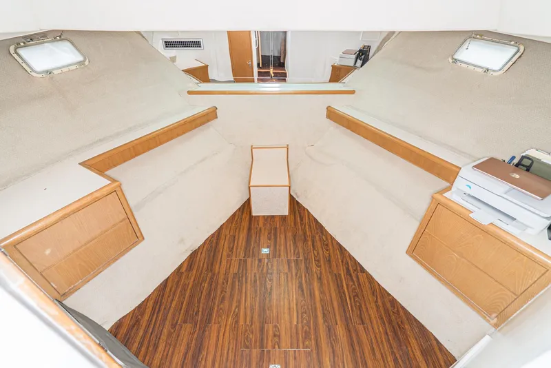 Slide: The Image of Interior of 1996 Hatteras 70 Sport Deck Motor Yacht with wood flooring and storage cabinets. - 17