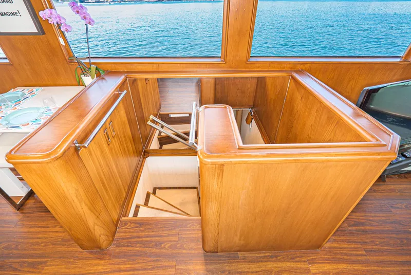 Slide: The Image of Interior of 1996 Hatteras 70 Sport Deck Motor Yacht with wooden stairs and large windows. - 22