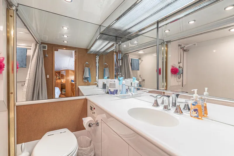Slide: The Image of Luxurious bathroom in 1996 Hatteras 70 Sport Deck Motor Yacht with modern fixtures and ample lighting. - 27