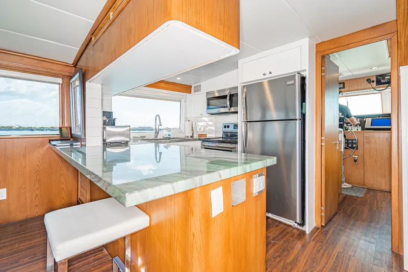 Slide: The Image of Interior of 1996 Hatteras 70 Sport Deck Motor Yacht with modern kitchen amenities. - 33