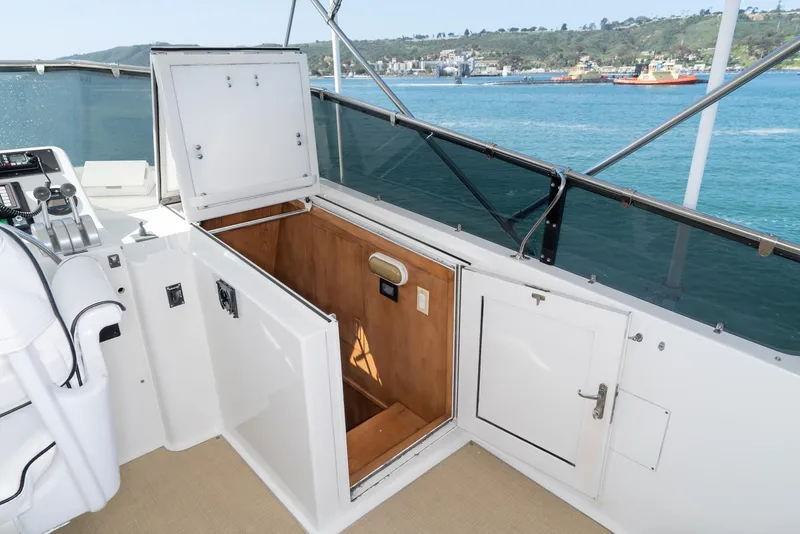 Slide: The Image of 1996 Hatteras 70 Sport Deck Motor Yacht interior with open hatch and ocean view. - 41