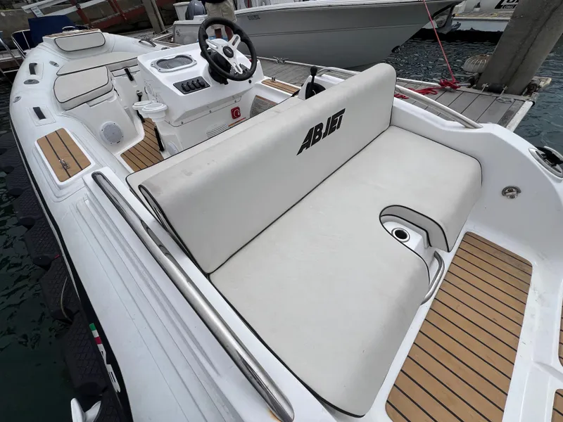 Slide: The Image of 2023 AB Inflatables ABJET 430XP boat with sleek white seating and modern design. - 11