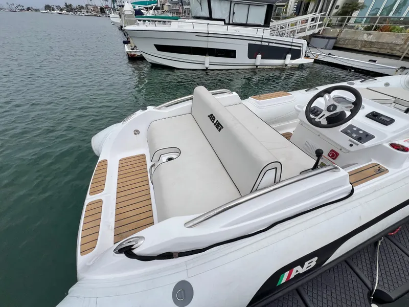 Slide: The Image of 2023 AB Inflatables ABJET 430XP boat docked, featuring sleek design and comfortable seating. - 7