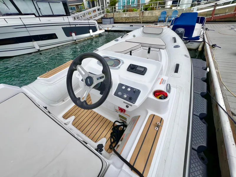 Slide: The Image of 2023 AB Inflatables ABJET 430XP boat docked, featuring sleek design and modern controls. - 8