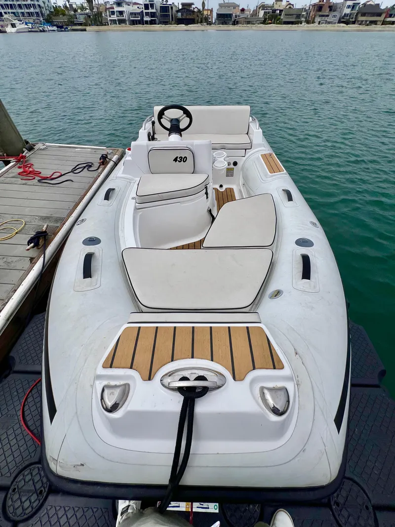 Slide: The Image of 2023 AB Inflatables ABJET 430XP boat docked by the water. - 9