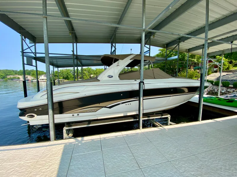 The Image of 2001 Sea Ray 290 Bowrider docked under a covered marina, side view. - 1