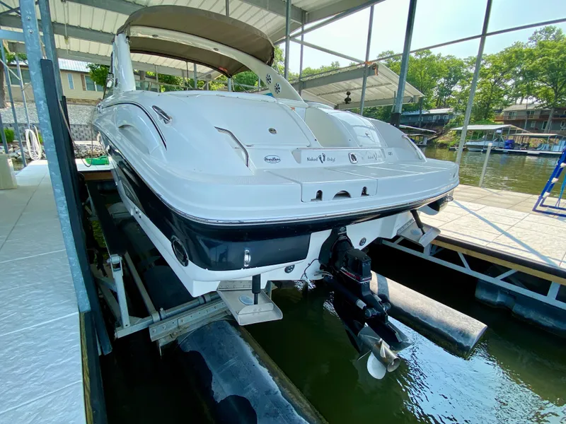 Slide: The Image of 2001 Sea Ray 290 Bowrider on lift in covered dock. - 10