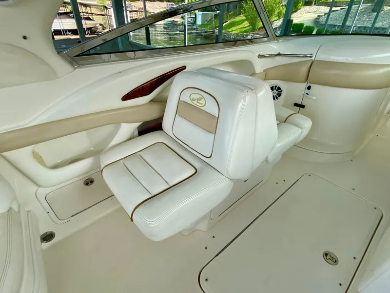 Slide: The Image of 2001 Sea Ray 290 Bowrider interior with white and beige seating. - 13