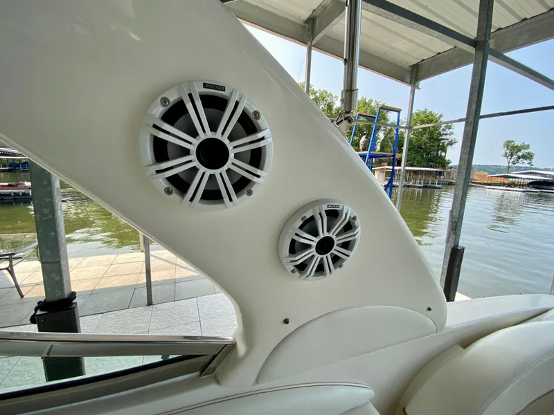 Slide: The Image of Speakers on a 2001 Sea Ray 290 Bowrider boat, docked by a lake. - 23