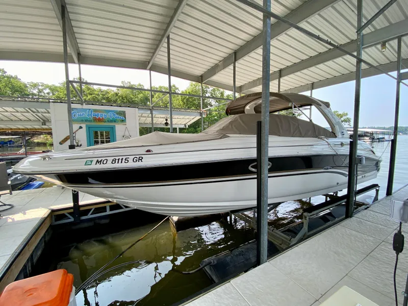 Slide: The Image of 2001 Sea Ray 290 Bowrider docked under a covered marina. - 3