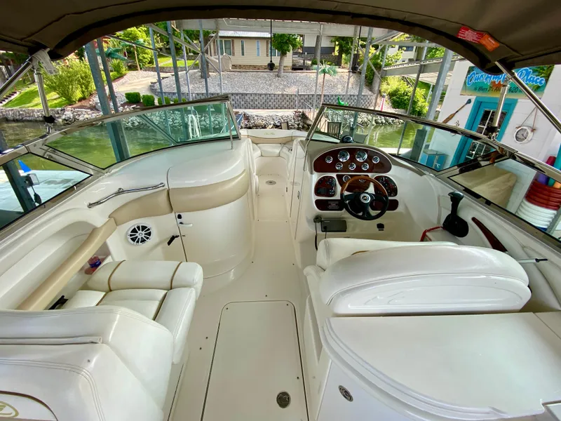 Slide: The Image of 2001 Sea Ray 290 Bowrider interior with white seating and control panel. - 31