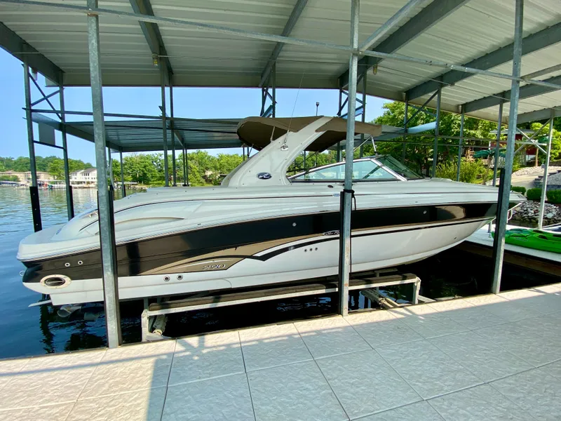 Slide: The Image of 2001 Sea Ray 290 Bowrider boat docked under a covered marina. - 6