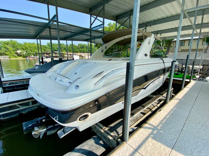 Slide: The Image of 2001 Sea Ray 290 Bowrider docked under a covered marina. - 7