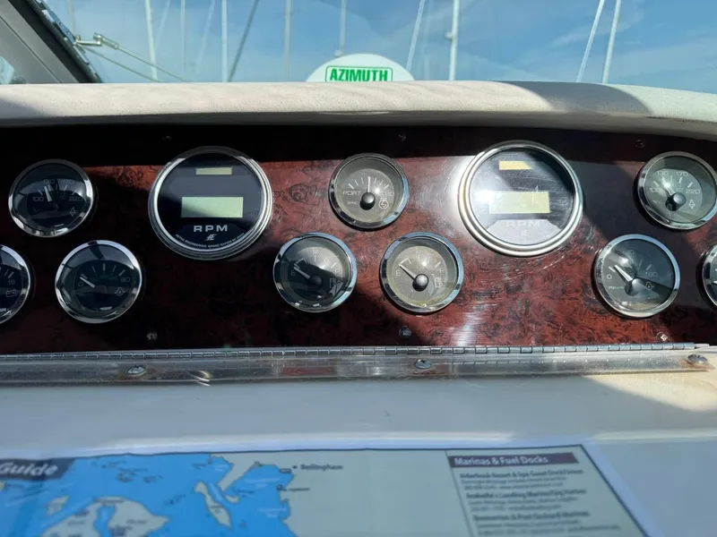 Slide: The Image of Dashboard of a 1997 Sea Ray 330 Sundancer boat with gauges and map. - 13