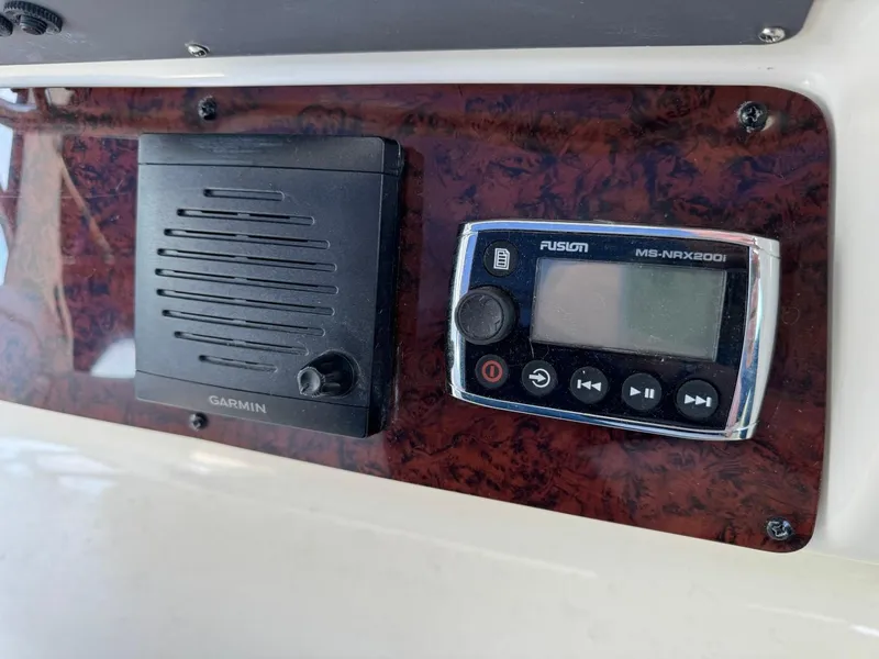Slide: The Image of Control panel on 1997 Sea Ray 330 Sundancer with Garmin and Fusion MS-NRX200i devices. - 15