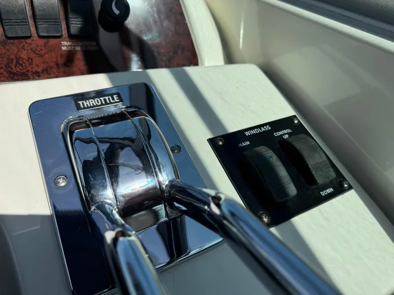Slide: The Image of Throttle and windlass controls on 1997 Sea Ray 330 Sundancer boat dashboard. - 16